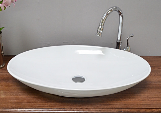 Large, oval washbasin as a countertop version